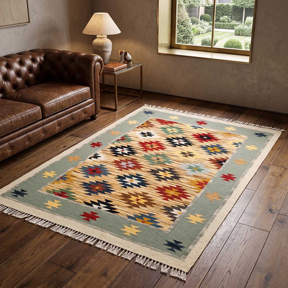 The Mirzapur Kilim rug styled in a modern living room setting showing the scale and pattern.