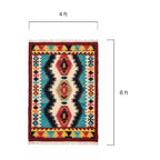 Close up detail of the intricate hand-woven wool texture and tribal patterns on the Mirzapur kilim rug