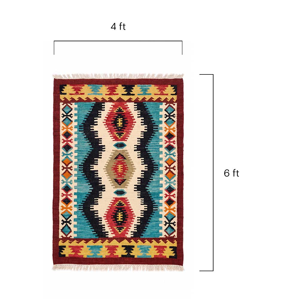 Close up detail of the intricate hand-woven wool texture and tribal patterns on the Mirzapur kilim rug