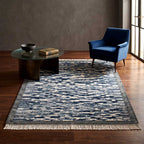 Edge detail showing the hand-knotted tassels of the navy and cream Mirzapur rug.