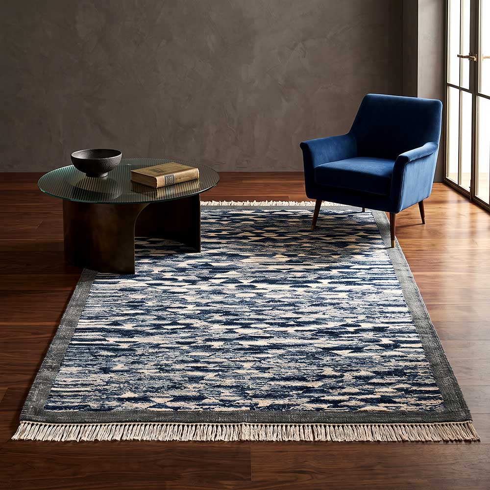 Edge detail showing the hand-knotted tassels of the navy and cream Mirzapur rug.