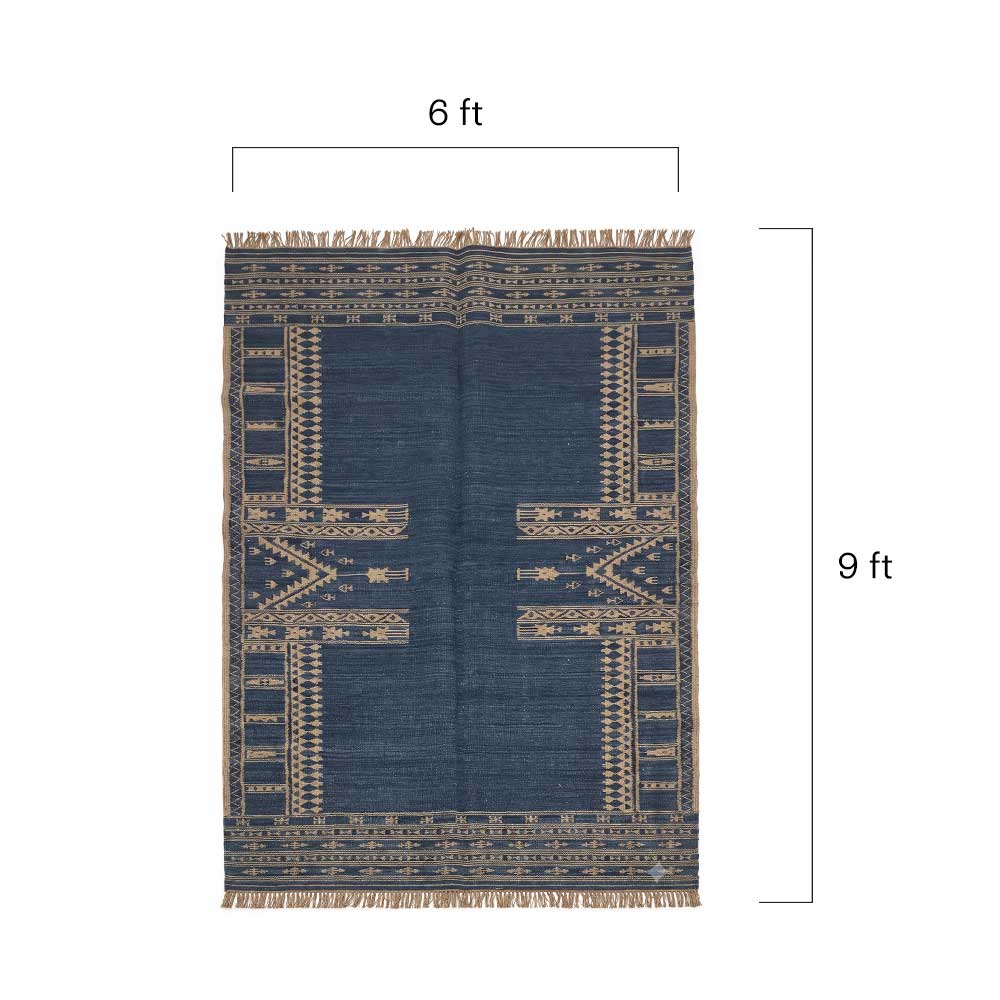 Close-up detail of the woven texture and geometric pattern of the navy Mirzapur area rug.