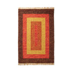 Rectangular rug with brown, red, and yellow pattern on a white background