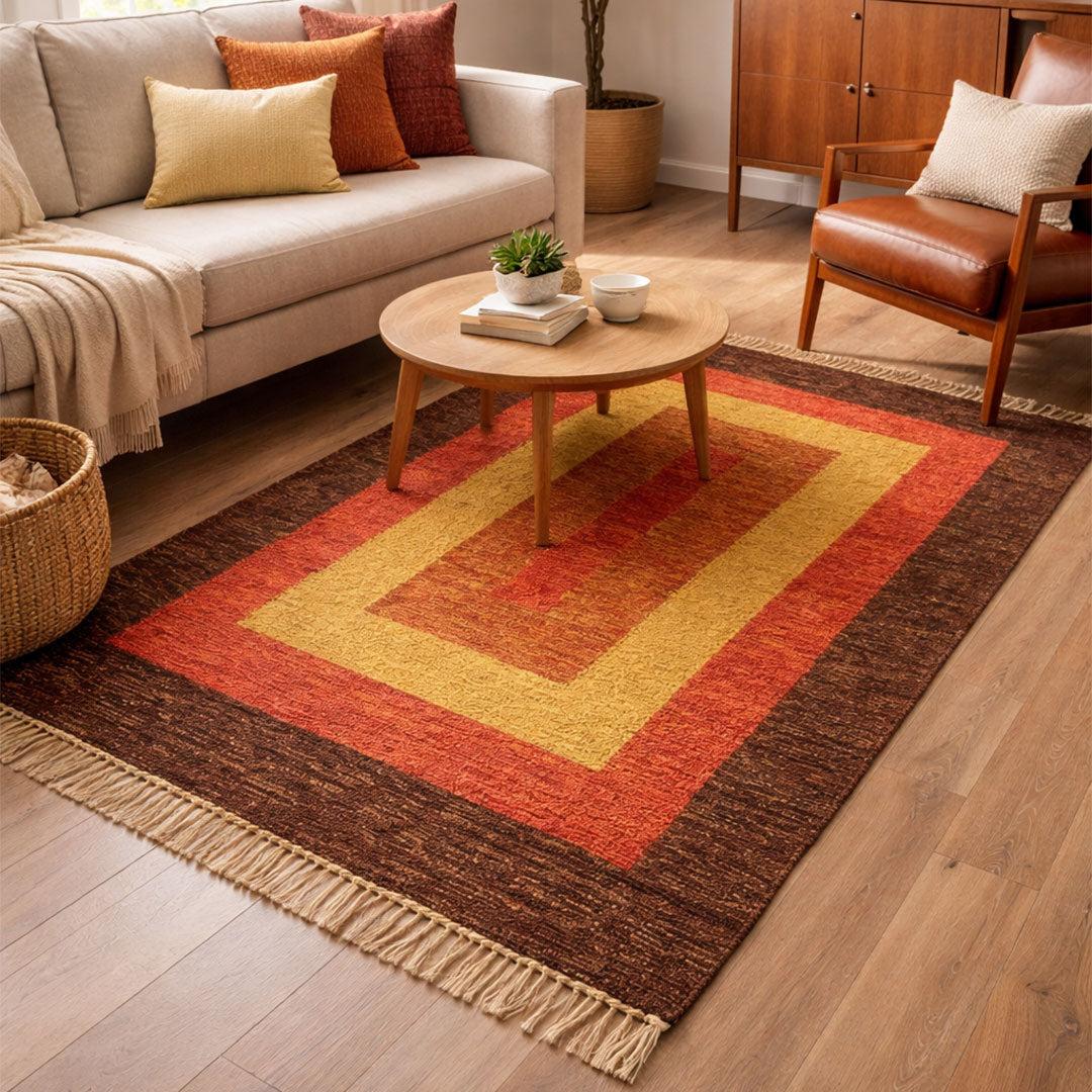 Living room with a colorful rug, sofa, and coffee table.