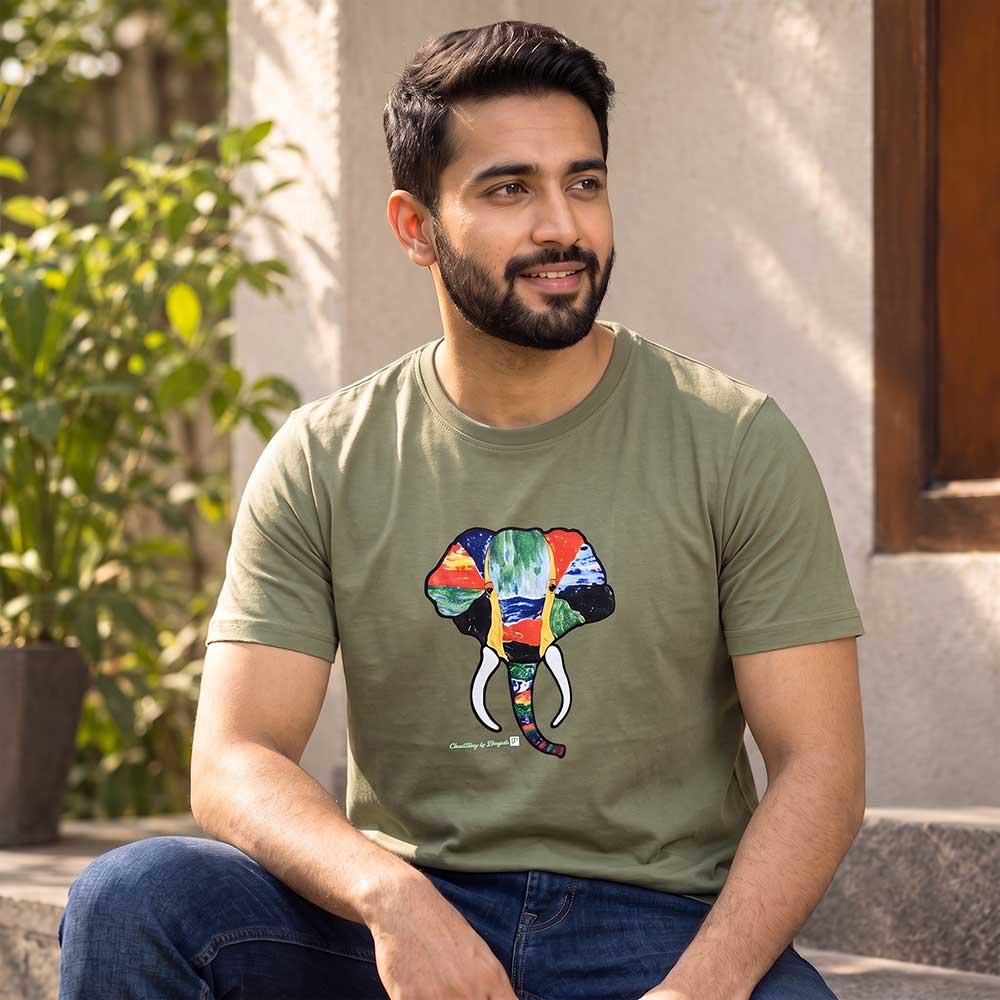 Close-up detail of the artisan hand-painted elephant graphic on the olive cotton t-shirt.