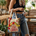 Person holding a decorative bag with a colorful design, standing in a casual setting.