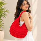 Side profile of the red crochet hobo bag showing capacity and shape