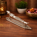 Decorative metal handle on a wooden surface with a warm background