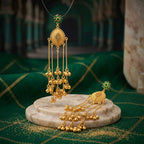 Side angle view of the hanging chain and bead construction of the gold plated earrings.