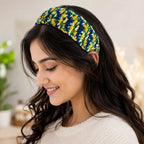 Woman wearing the vibrant primary-colored handmade crochet headband.