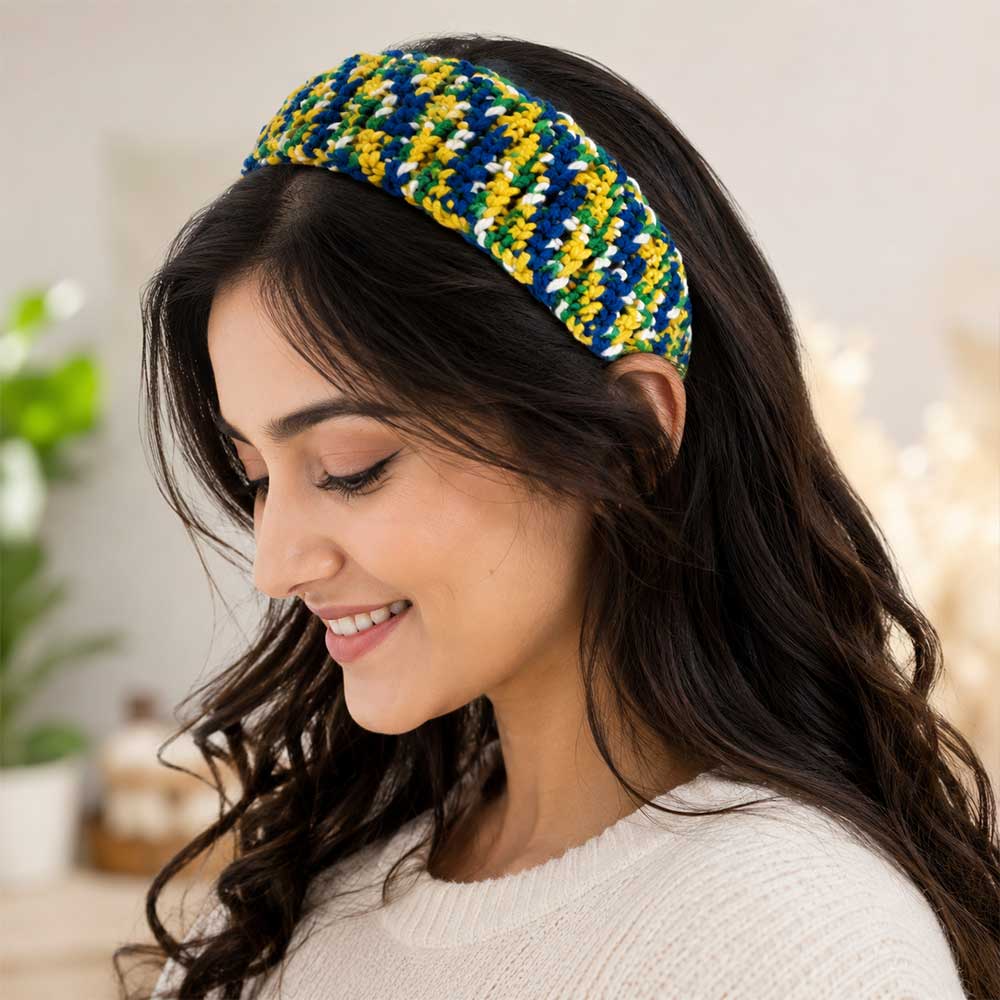 Woman wearing the vibrant primary-colored handmade crochet headband.