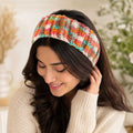Woman wearing the sunset-colored handmade crochet headband.